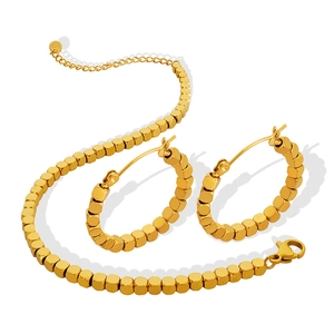 Golden titanium steel jewelry set featuring movable cube beads bracelet and hoop earrings