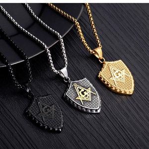 Detail of Masonic shield pendants in black, gold and silver on titanium steel necklaces