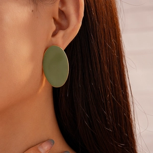 Detailed view of matte olive green oval earrings with elegant gold metallic edges