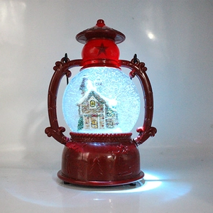 Detail of red Christmas lantern featuring lighted snow scene and internal house landscape