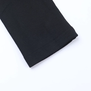 Macro view showing tight knitted texture and double-stitch cuff detail on black top