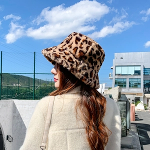 Close-up of leopard print faux fur bucket hat showing plush texture and warm material