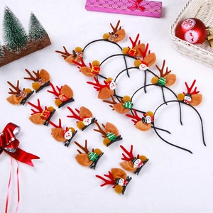 Flat lay of Christmas hair accessories with plush antlers and festive decorations