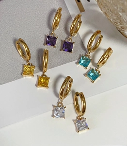 Detailed close-up of square zircon pendant earrings in purple, yellow, blue, and clear colors