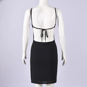 Detail of the backless black dress with spaghetti straps and tie-up back design