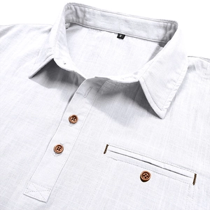 Detail of white cotton linen shirt showing lapel collar, wood buttons and chest pocket