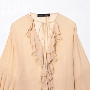 Elegant beige V-neck blouse with ruffled flare sleeves and delicate tie-up front detail