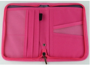 Detail view of pink travel organizer showing internal card slots and zipper pocket