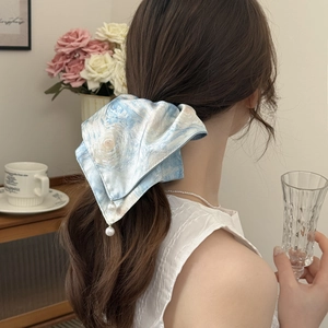 Starry sky tie-dye scrunchie with pearls on a ponytail in a cozy indoor setting