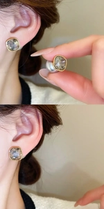 Detail of square gem earrings with gold frame showing dual-wear style with pearl backings