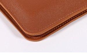 Close-up of brown leather bag showing premium stitching and smooth rounded edge detail