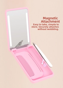 Detail of pink LED makeup mirror with magnetic storage for comb and tweezers