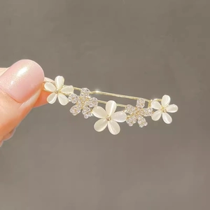 Elegant gold flower hair clip with white petals and sparkling rhinestones for women