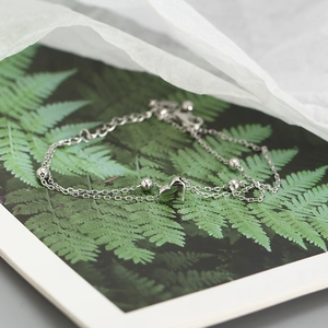 Detailed shot of double-layer S925 silver heart pendant bracelet with lobster clasp