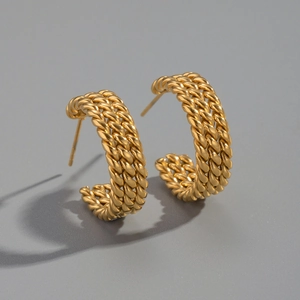 Macro view of golden stainless steel triple twisted rope texture hoop earrings