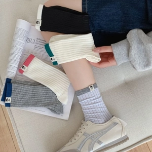 Minimalist Japanese style ribbed crew socks in multiple colors with cartoon fabric label