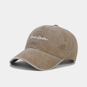 Detail of vintage washed coffee baseball cap with white baba embroidery and curved brim