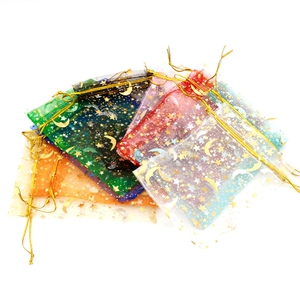 Detail of colorful organza gift bags with gold star and moon patterns and drawstring