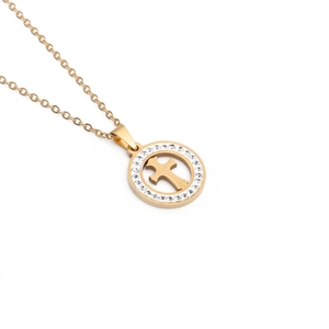 Detailed shot of a gold-plated circular pendant with cross cutout and sparkling rhinestones