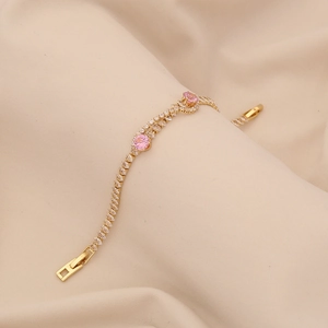 Elegant gold bracelet for women featuring pink center stones and cubic zirconia accents