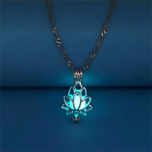 Close-up of glowing blue lotus locket pendant on silver chain for yoga jewelry