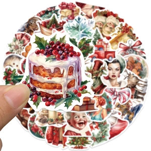 Close-up of vintage Christmas sticker pack showing size with finger holding cake decal