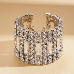 Close-up of wide luxury bracelet featuring multi-row rhinestones and rectangular crystals