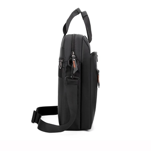 Side view of black nylon men's briefcase with adjustable shoulder strap and top handle