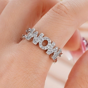 Macro shot of silver MOM ring with cubic zirconia micro-paving and curb chain band