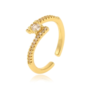 Golden adjustable ring with square zircon and side crystals on a white background