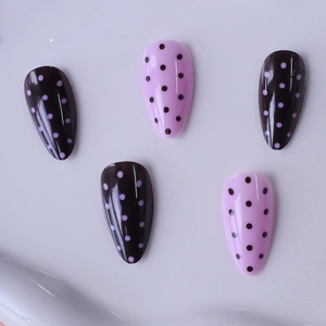 Pink and purple almond press-on nails with polka dot design and glossy finish
