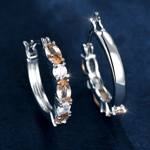 Silver hoop earrings with champagne and clear oval cubic zirconia in prong setting