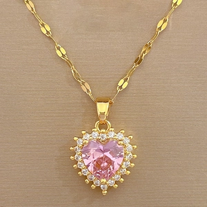 Detailed macro of pink heart pendant with micro-pave diamonds on a gold titanium necklace