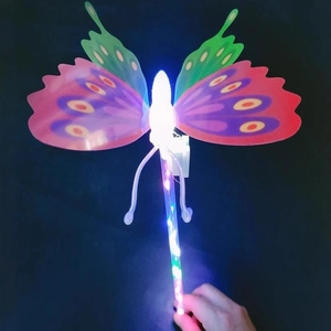 Glowing LED butterfly fairy wand toy with colorful wings and flashing lights on black background