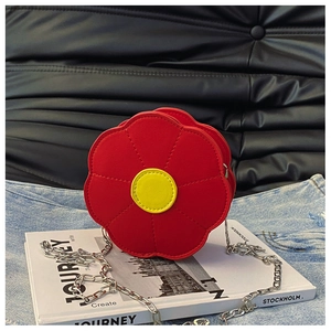 Close-up of red and yellow sun flower shaped PU leather crossbody bag with silver chain strap