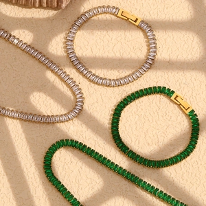 Macro detail of luxury emerald green and clear zircon necklace set in gold plating