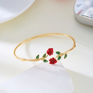 Detailed shot of rose enamel open bangle with red flowers and green leaves in gold finish