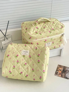 Quilted makeup bags with pink tulip patterns in various sizes on a bright desk