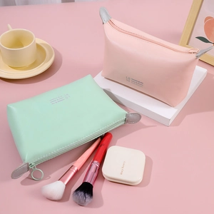 Pink and mint green PU leather travel makeup bags with LOVE print and zipper closure