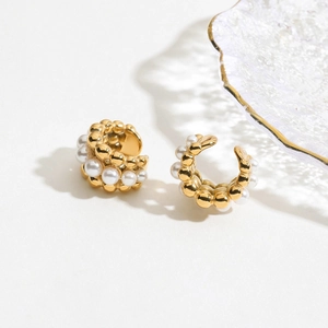 Elegant 18K gold stainless steel ear cuffs featuring small white pearls on a white surface