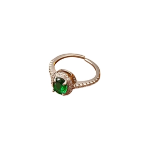 Adjustable silver ring featuring an oval green zircon centerpiece and pavé accent stones