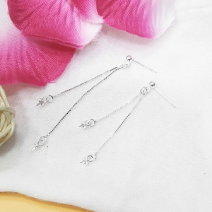 Macro shot of S925 sterling silver ball stud earrings with double box chain tassels