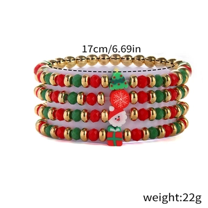 Detailed view of four-piece Christmas beaded bracelets with Santa and snowflake charms