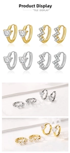 Détail de boucles d'oreilles dorées et argentées serties de zircons en forme de cœur