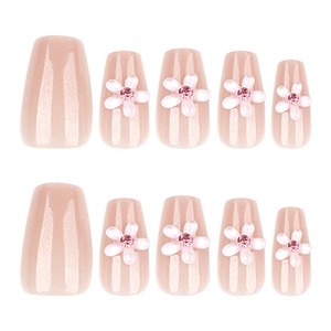 Short ballet fake nails with glitter nude base and 3D white flowers with pink rhinestones