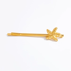 Detailed view of a polished 18k gold starfish hair clip featuring a sea life design