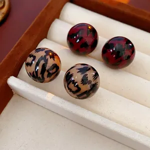 Classic round leopard print stud earrings set in khaki and red tortoiseshell patterns