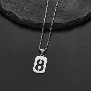 Macro shot of silver stainless steel number 8 pendant hanging over dark textured stone