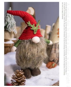 Detailed knit texture of Christmas gnome ornament on snow with rustic pine cones