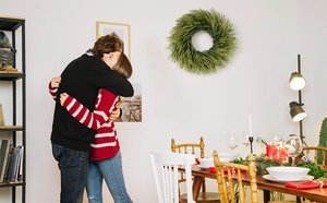 Realistic artificial pine needle garland hanging on a wall in a cozy home setting